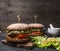 Appetizing homemade burgers with chicken in mustard sauce with arugula and herbs on a cutting board text area on wooden rusti