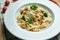 Appetizing, homemade pasta tagliatelle with broccoli, blue cheese and chicken in a white plate on a wooden background.