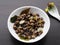 Appetizing little mushrooms in a plate on a dark table