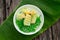 Appetizing Lod Chong placed on a green banana leaf on a wooden table