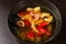 Appetizing looking seafood soup with mussels shrimp red pepper in a plate on a wooden table. medium shot