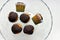 Appetizing muffins in chocolate glaze on glassware on white