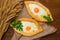 Appetizing open pies with cheese and eggs on sackcloth