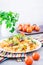 Appetizing pasta with fried mushrooms and fresh herbs on a plate