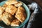 Appetizing picture of food, blue plate with a square home cookie on a background of a dark wooden table. Cookie structure.