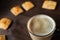 Appetizing picture of food, a cup with fragrant coffee, mocha, milk close-up against a dark wooden table. Structure of coffee foam