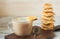 Appetizing picture of food, a cup with fragrant coffee, mocha, milk on a turret background of a square cookie