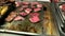 Appetizing pieces of fried beef meat on a large baking sheet in the hotel restaurant