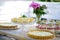 Appetizing pies and lemonade are cooked on a white wooden picnic table with a vase of peony flowers. Summer family vacation.