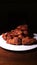 Appetizing plate of chicken wings on a dark background