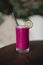 Appetizing purple smoothie atop a wooden table, garnished with a slice of lime
