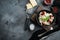 Appetizing ravioli with tomato sauce  cheese and basil with basil parmesan and tomatoe in black bowl   on gray background   top