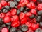 Appetizing red and black jelly candies in the shape of a blackberry close-up