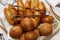 Appetizing Russian portioned pies on the table in a basket. Catering for events, celebrations and business meetings. Close-up