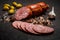 Appetizing salami smoked sausage with garlic and green olives