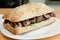 Appetizing sandwich with ciabatta bread, beef, lettuce, and sauce
