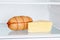 Appetizing sausage and cheese on refrigerator shelf