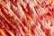 Appetizing slices Iberian ham in the foreground as a texture. Raw meat that becomes an article of haute cuisine and gastronomic