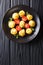 Appetizing snack Duchess Potatoes closeup on a black plate on a