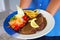 Appetizing stake on plate and golden french fries and green vegetables.