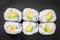 Appetizing sushi maki roll avocado on a black stone plate