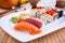 Appetizing sushi with wasabi, fruits and chopsticks