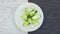 Appetizing tasty cucumber salad on a white rotating plate. Top view from above