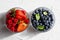 Appetizing variety of forest fruits strawberries, large strawberries, raspberries, blueberries, red berries in a glass bowl and