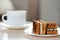 Appetizing waffles with creamy toppings on a plate. On a blurred background cup of coffee