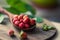 Appetizing wild strawberry in a wooden spoon on the table. Berry in the morning light, a healthy breakfast. Diet Concept