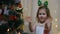 Applause. baby clapping. Child girl in anticipation of santa and a gift at Christmas. New Year and Christmas tree.