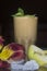 Apple banana smoothie. Drink in a glass. Flower on the table