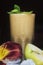 Apple banana smoothie. Drink in a glass. Flower on the table