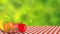 Apple, Banana, watermelon, orenge and strawberry on picnic cloth on green blur background.