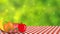 Apple, Banana, watermelon, orenge and strawberry on picnic cloth on green blur background.