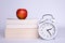 apple, book and watch on a white background