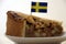 Apple cake triangular cut from big round cake with Sweden toothpick flag.