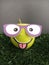 Apple character wearing glasses on a grass  background