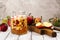 Apple cider sangria in a glass jar on wooden table