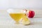 Apple cider vinegar in a glass gravy boat on a light background with red apples. Malic acid is beneficial for health and