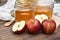 Apple cider vinegar on wooden board, Kombucha tea with apple slices, Healthy probiotic nutrition drink.