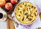 Apple clafoutis, red apples and cup of coffee