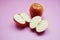 Apple cut half slices on pink background