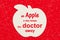 An apple a day keeps the doctor away message with a wood apple