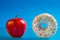 Apple and donut, concept of choice health and unhealthy diet