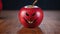 Apple evil smiling - carved evil smile on apple, knife rests nearby on wooden surface, indoor lighting.