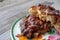 An apple fritter pastry for breakfast torn in half with chunks of apples on the inside