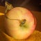 Apple fruit  with leaf placed on a yellow cloth napkin