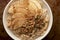 Apple Granola Porridge Bowl Closeup on Brown Background