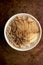 Apple Granola Porridge Bowl Top View on Brown Background